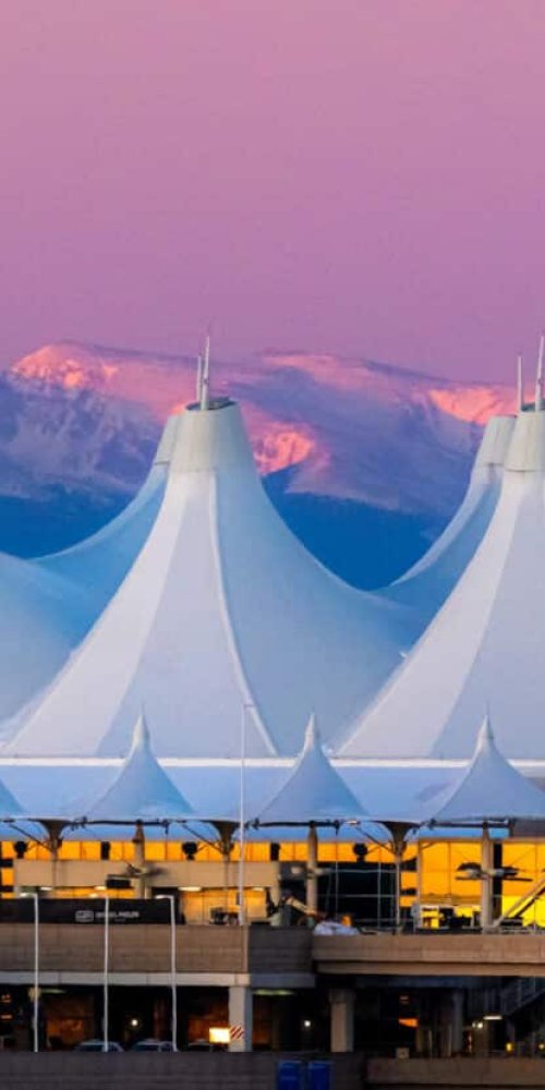 Car driving near Denver skyline